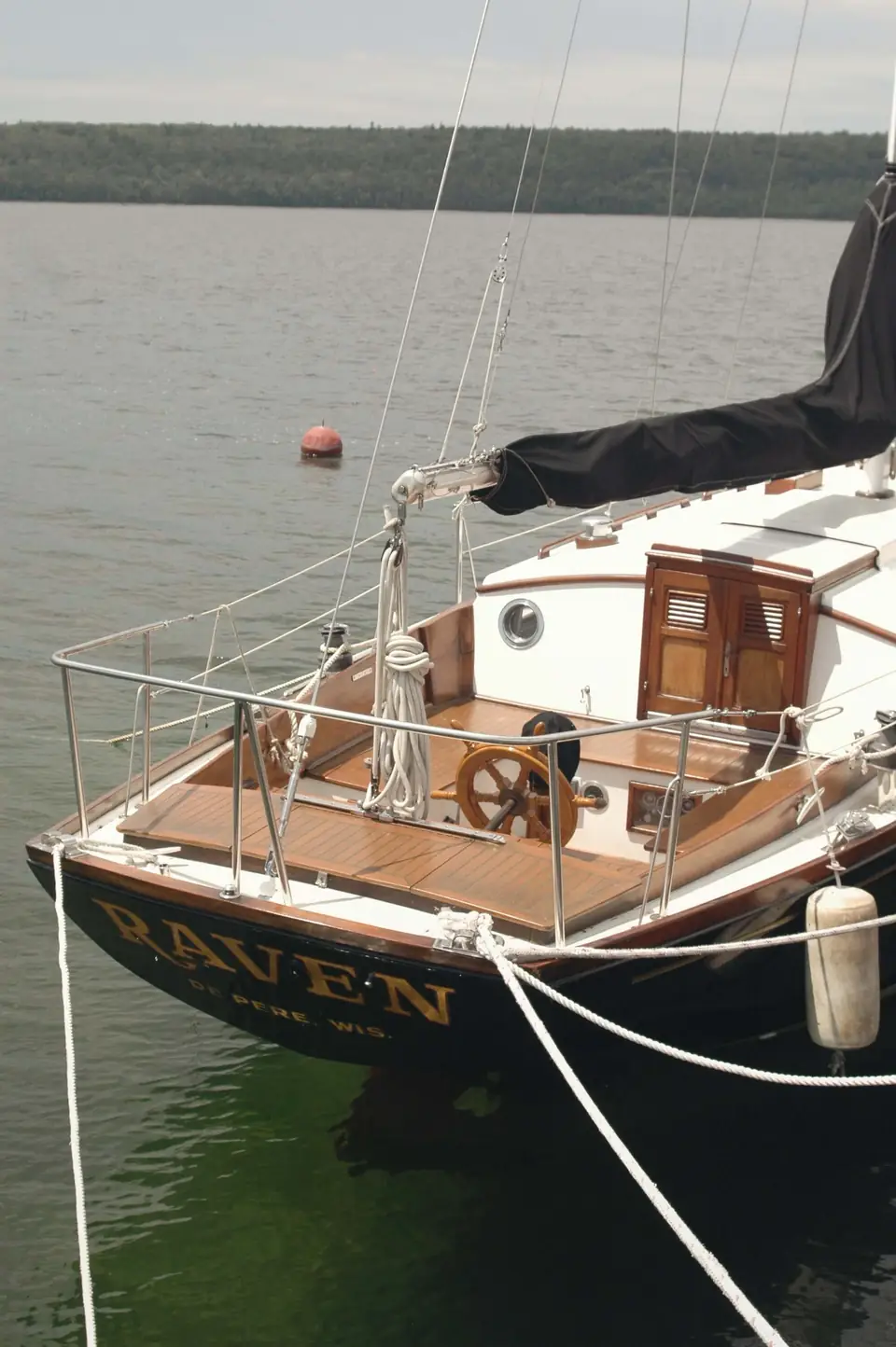Classic wooden-trimmed sailboat Maven at her mooring