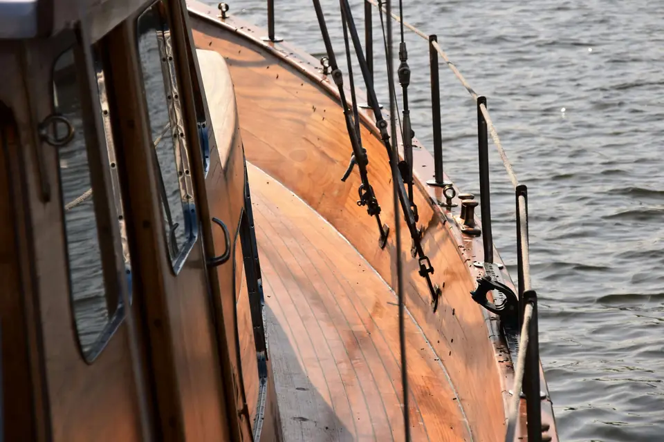 Varnished teak cabin sides and coaming on a classic sailboat